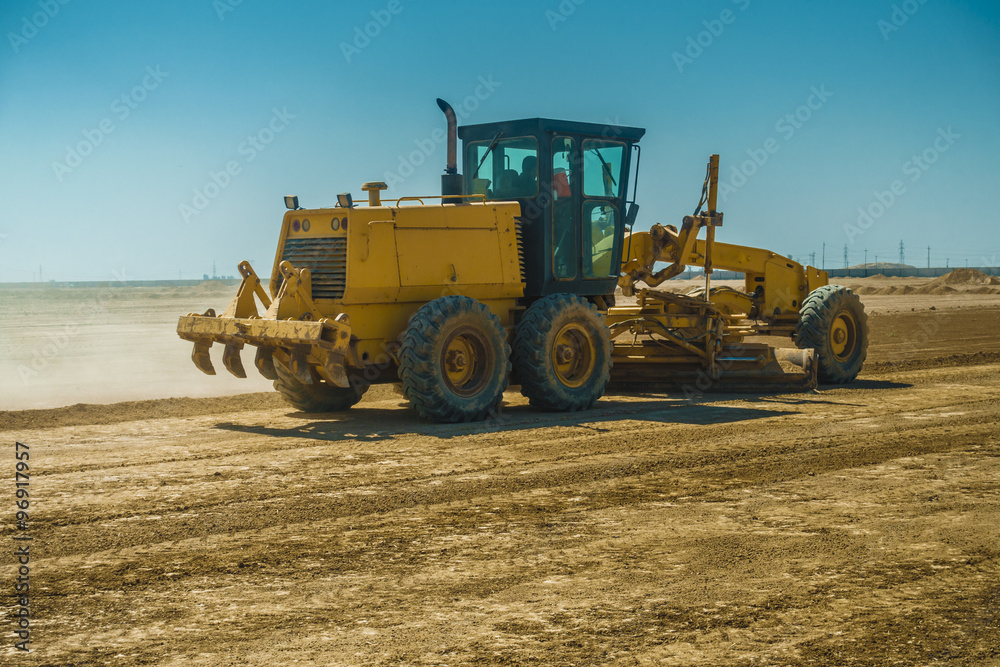 Grader in Leveling soil for construction project in Iraqi desert Grader in Leveling soil for construction project in Iraqi desert