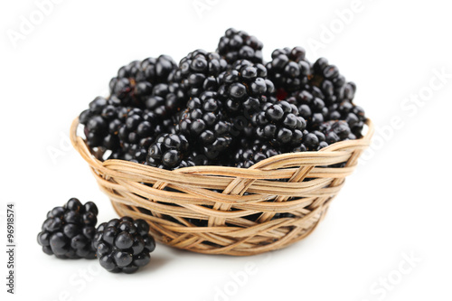 Beautiful ripe blackberry in basket on white background