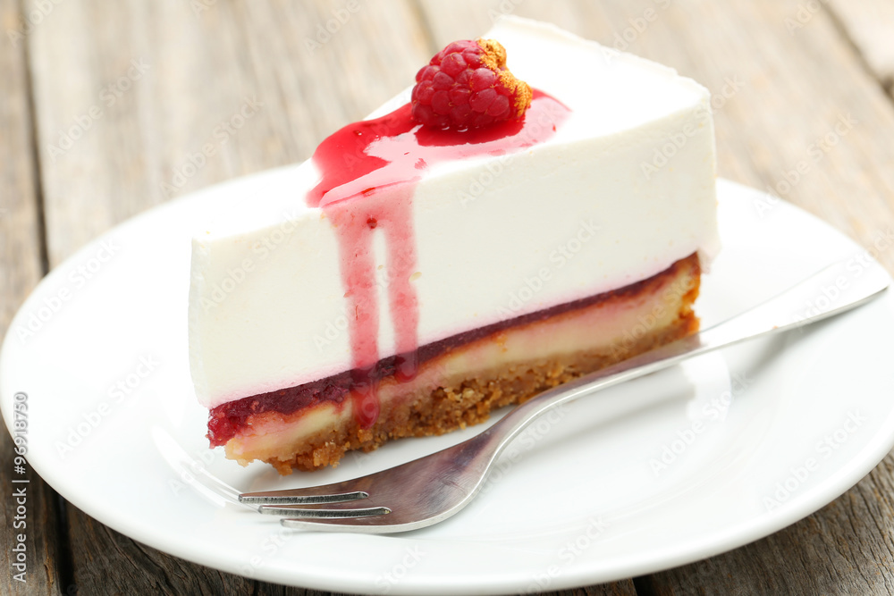 Fresh raspberry cheesecake on white plate