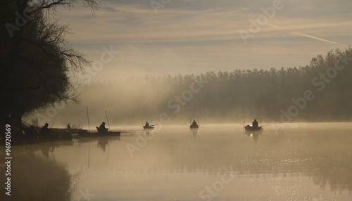 People fishing in the early morning on the lake