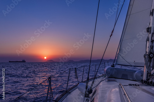 Sailing in the dusk in the Aegean sea, Greece, with beautiful sunset colors