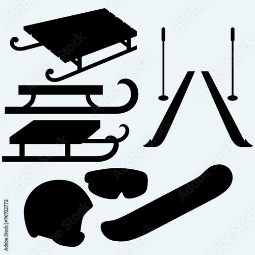 Set equipment for snowboarding, pair skis and wooden sled. Isolated on blue background. Vector silhouettes