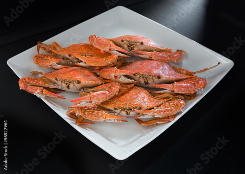 Close-up steamed crabs on black background