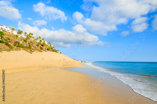 Fototapeta Naklejka Na Ścianę i Meble -  Beautiful sandy Morro Jable beach with ocean wave, Fuerteventura, Canary Islands, Spain