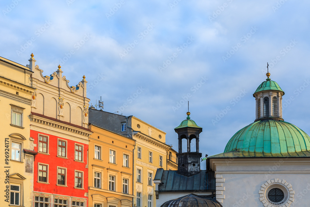 Colourful houses and church building on market square in Krakow, Poland