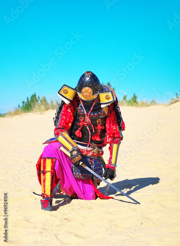 Man in samurai costume with sword. 