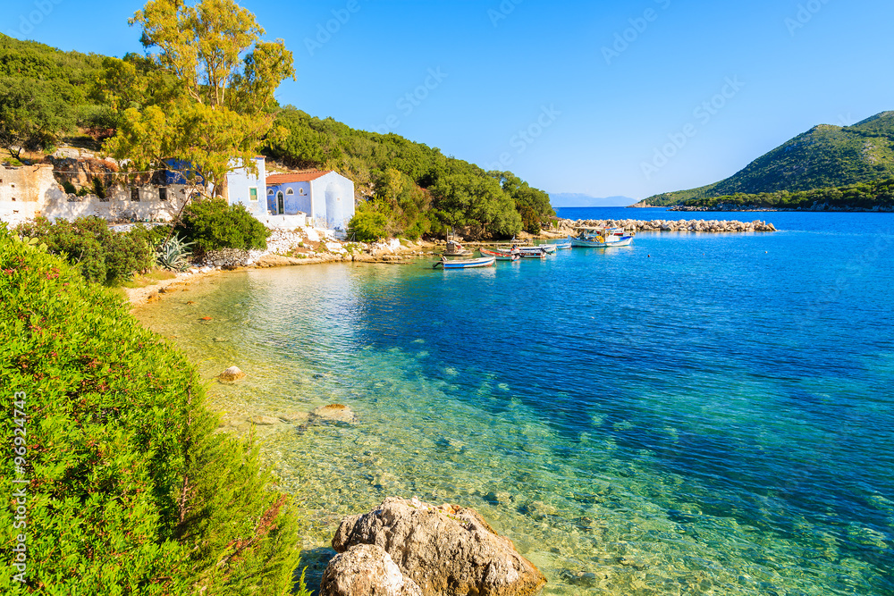 View of bay with old house and fishing boats, Kefalonia island, Greece