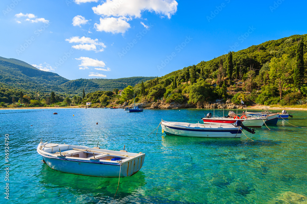 Greek fishing boats on turquoise sea water in beautiful bay, Kefalonia island, Greece