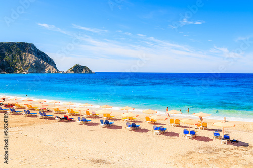 Fototapeta Naklejka Na Ścianę i Meble -  Sunbeds and umbrellas on beautiful Petani beach, Kefalonia island, Greece