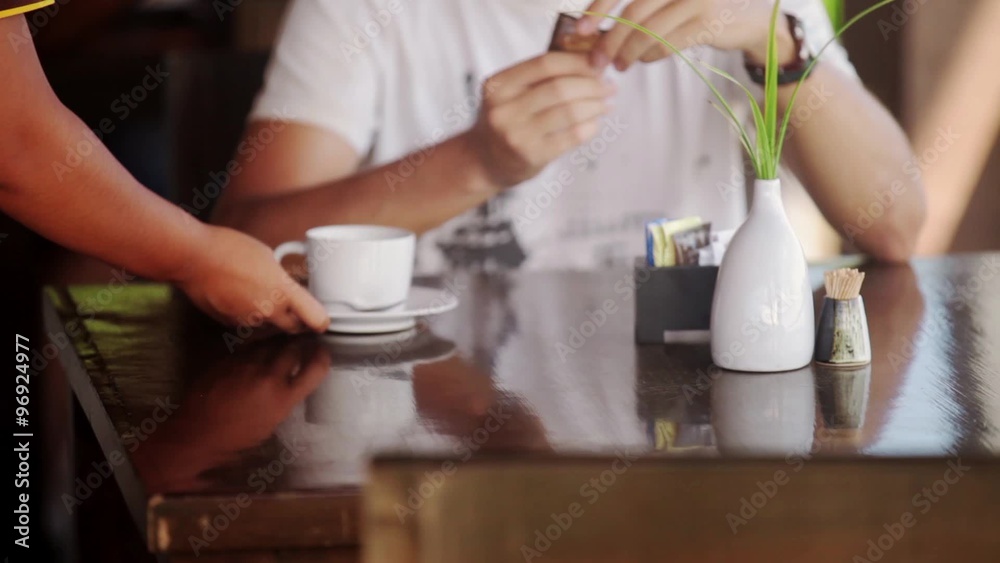Man is being sereved by waitress. Tea order Man is being sereved by waitress. Tea order