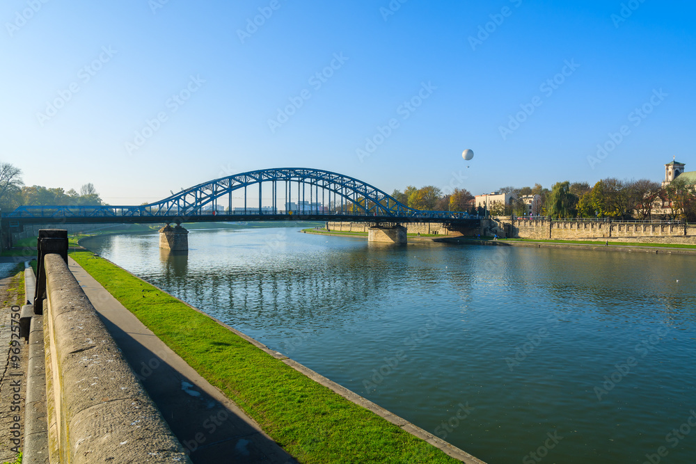 Bridge over Vistula river on sunny autumn day in city of Krakow, Poland