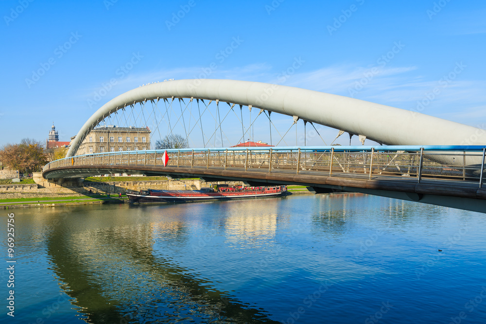 Obraz premium Bernatka bridge over Vistula river on sunny autumn day in city of Krakow, Poland