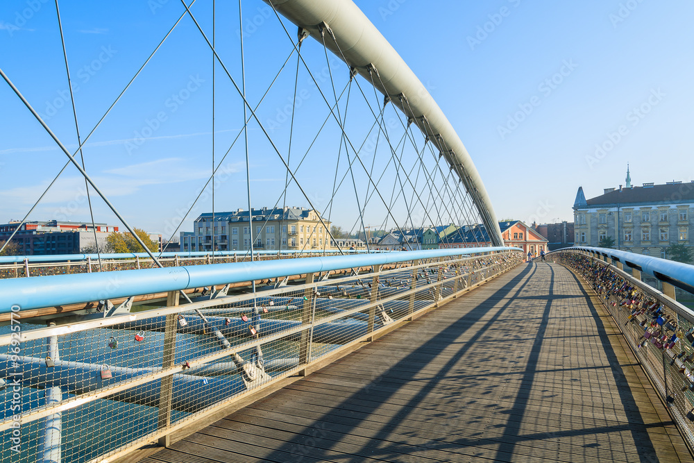 Obraz premium Bernatka bridge over Vistula river on sunny autumn day in city of Krakow, Poland