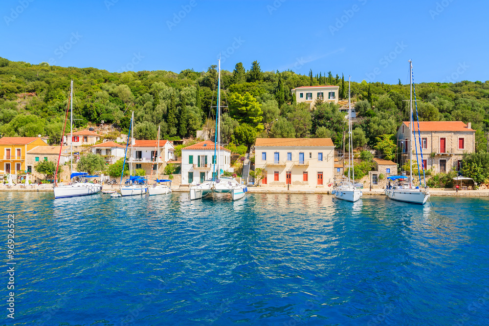 View of colorful houses and sailing boats in Kioni port on Ithaka island, Greece
