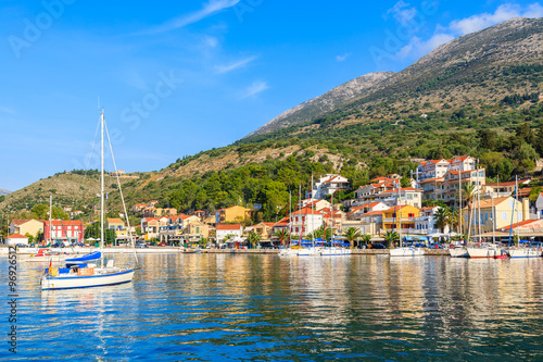 Yacht boat on sea and view of Agia Efimia village on Kefalonia Island, Greece