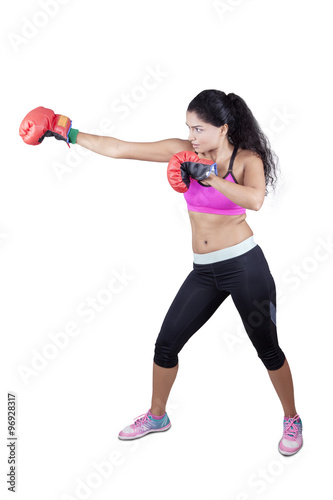Woman punching something with boxing gloves