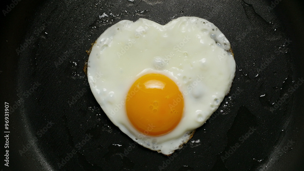 Cooking fried egg in the form of heart. Сlose-up 4K UHD 2160p footage.
Cooking fried egg in the form of heart. Сlose-up 4K UHD 2160p footage.