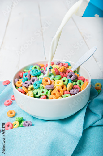 Milk pouring into plate with Colorful cereal