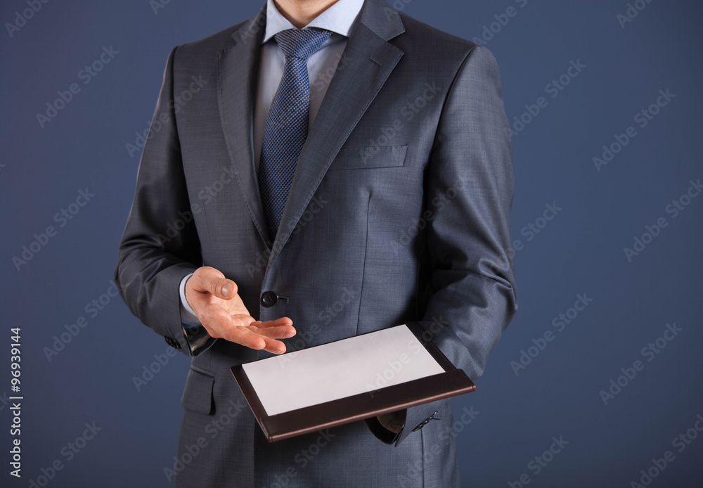 Businessman holding a clipboard with empty sheet of paper Businessman holding a clipboard with empty sheet of paper