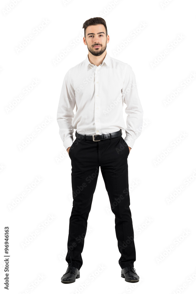 Confident elegant business man with hands in pockets looking at camera. Full body length portrait isolated over white studio background. Confident elegant business man with hands in pockets looking at camera. Full body length portrait isolated over white studio background.