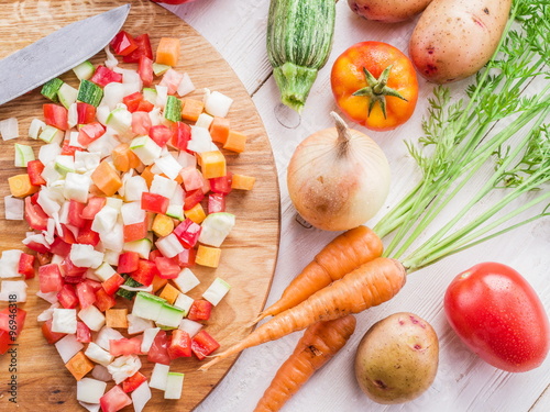 Fresh cut vegetables on the wooden chopping board.