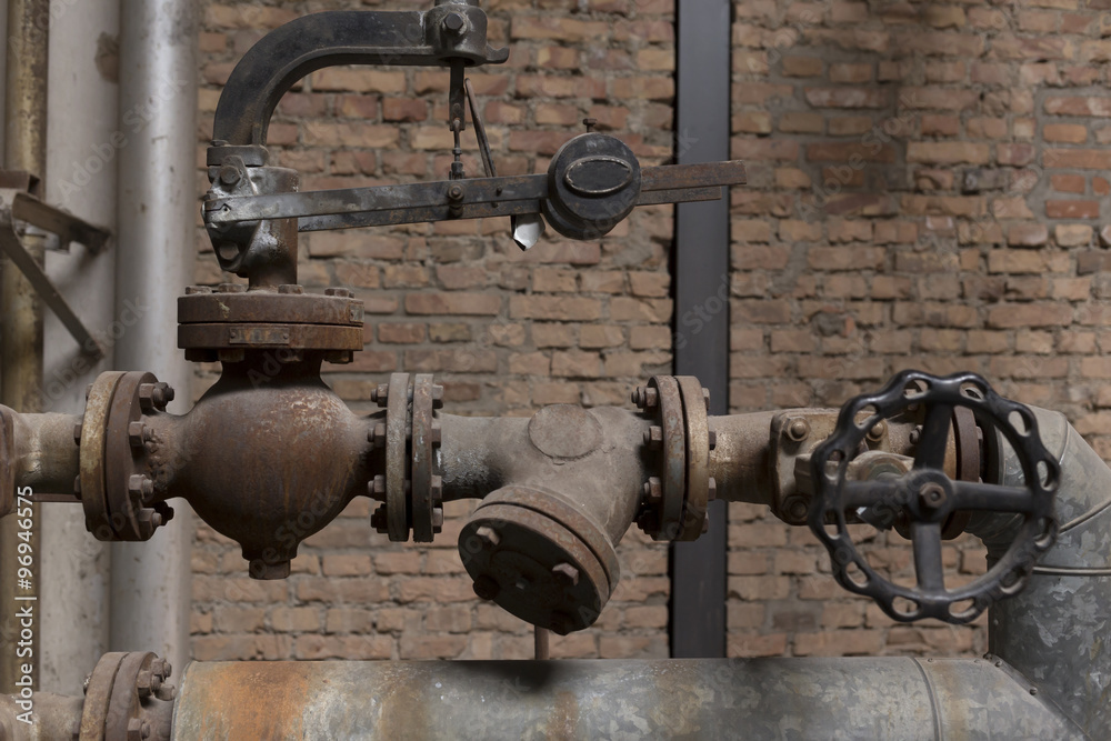 A set of old pipes in an old abandoned factory A set of old pipes in an old abandoned factory