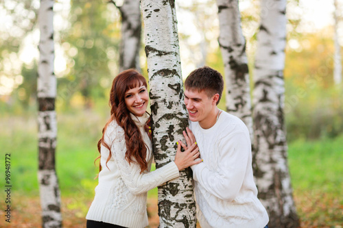 love, happy couple in park with birch trees, summer, autumn suns