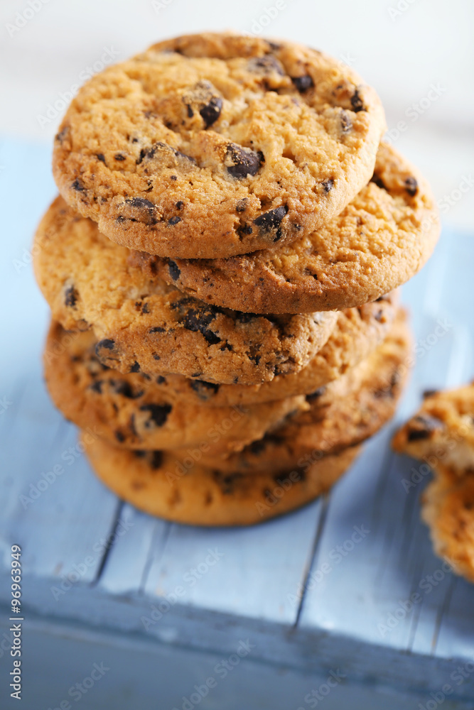 Cookies with chocolate crumbs on blue wooden table against blurred background, close up Cookies with chocolate crumbs on blue wooden table against blurred background, close up