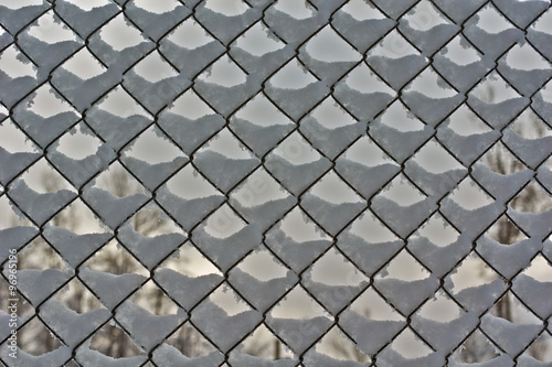 Fence made of wire mesh with frost.