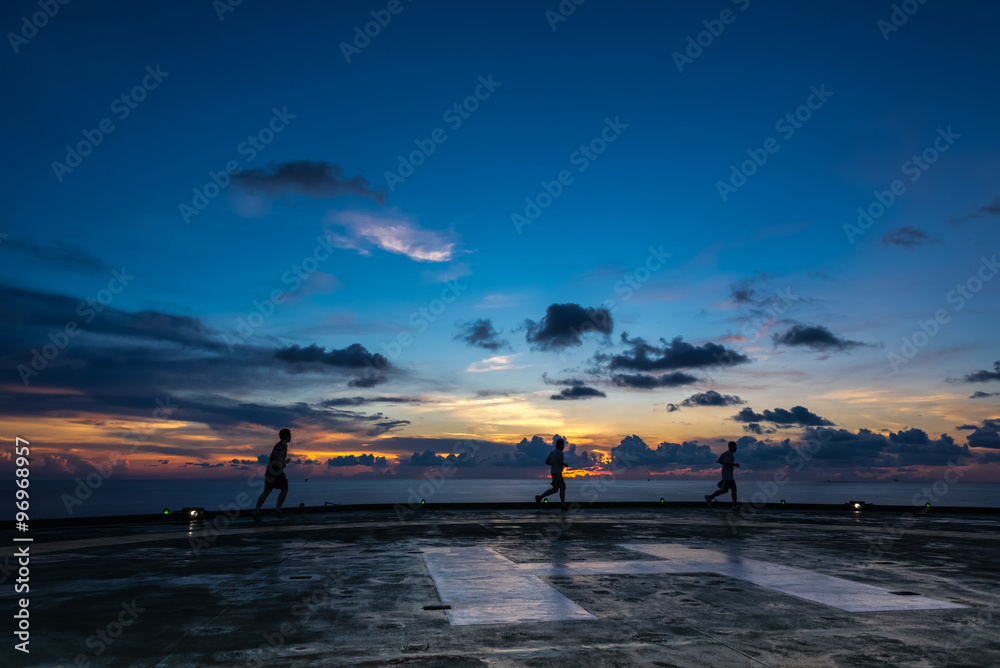 Ταπετσαρία Three men running on oil rig helipad in sunset time
