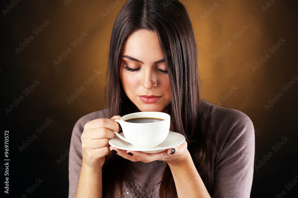 Woman holds cup of coffee and saucer in hands, close up Woman holds cup of coffee and saucer in hands, close up