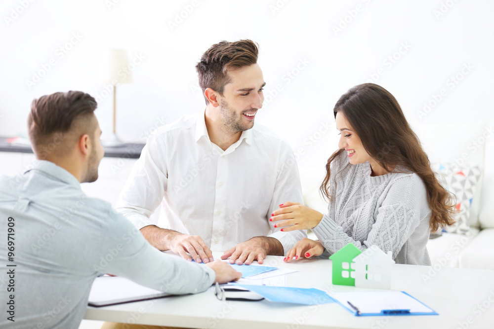 Happy family with estate agent, in bright office Happy family with estate agent, in bright office