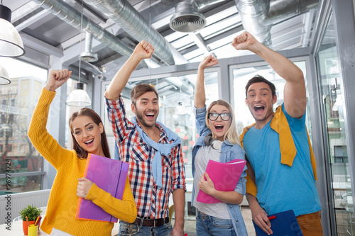 Φωτογραφία Cheerful four colleagues are happy for well-done work
