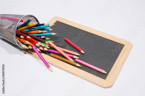 Colorful pencils against black chalk board, blank copy space