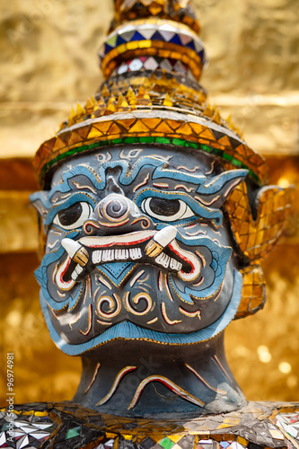 Close-up of demon guarding Golden Stupa at Wat Phra Kaeo in the Grand palace, Bangkok, Thailand © PirahaPhotos