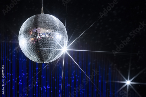 Disco ball with stars in nightclub with striped blue and black walls lit by spotlight, party and nightlife entertainment industry