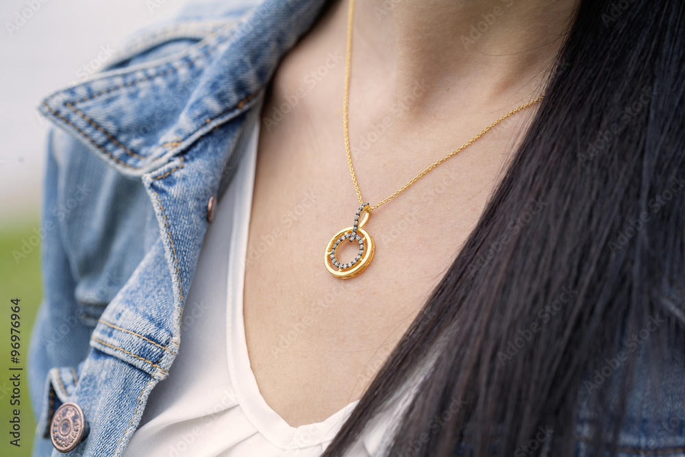 golden pendant in woman's decollete golden pendant in woman's decollete