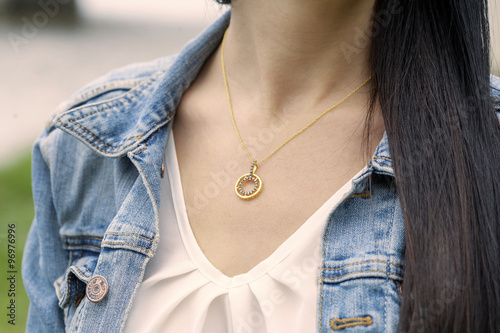 golden pendant in woman's decollete photo