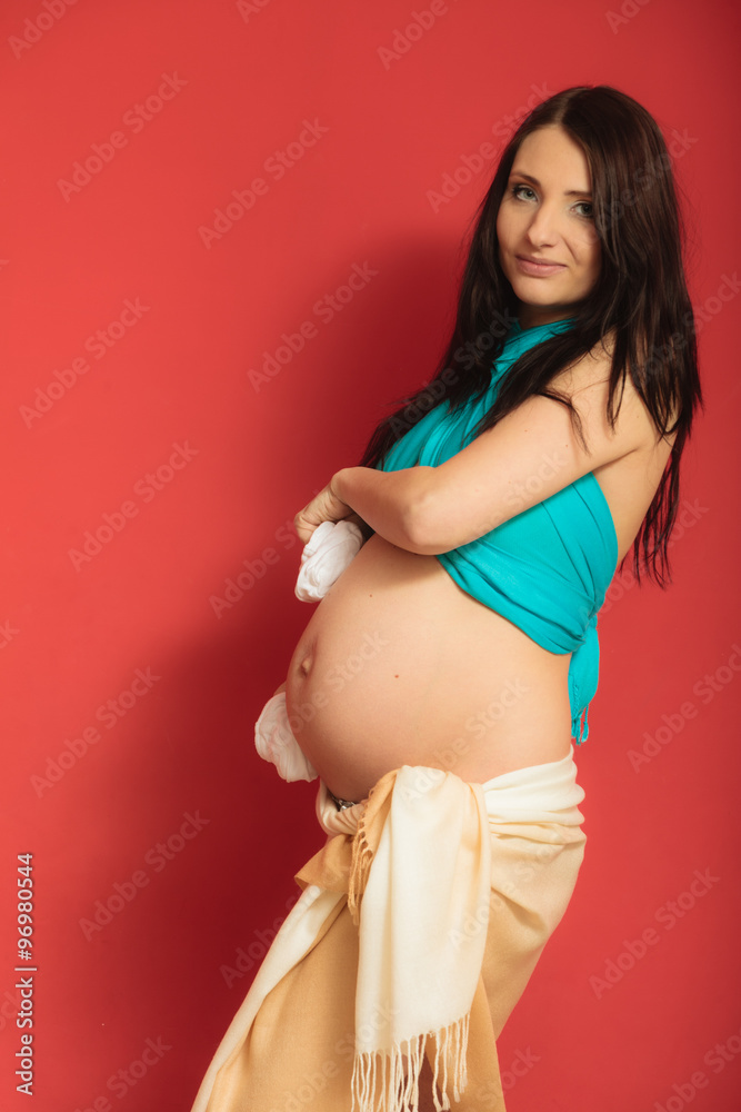 pregnant woman with small shoes for unborn baby pregnant woman with small shoes for unborn baby