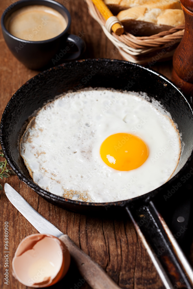 Breakfast setting with fried egg and coffee