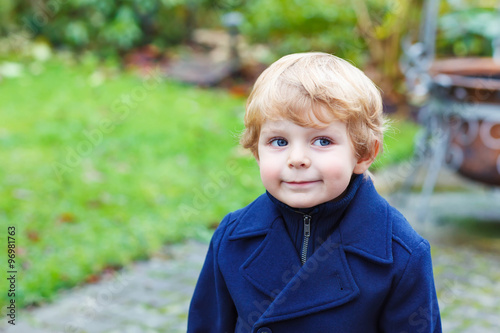 Portrait of little toddler boy on autumn day