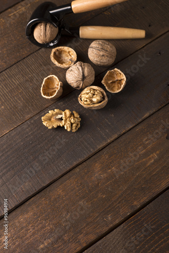 walnuts with nutcracker on a rustic table