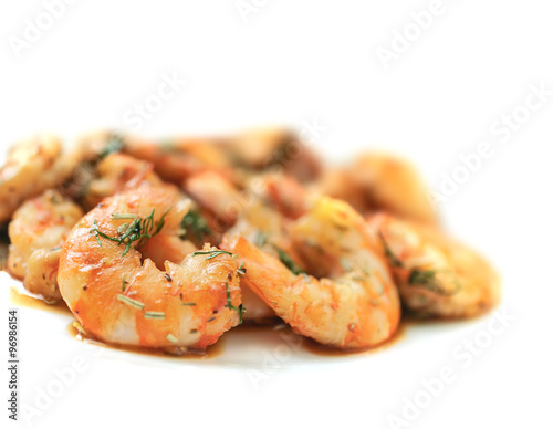 Fried black tiger prawns with herbs and spices on a white background