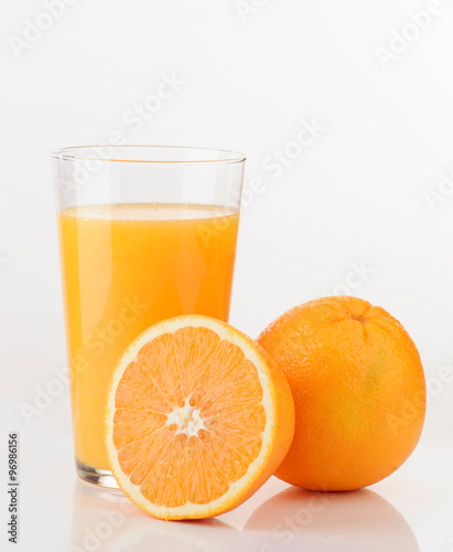 glass of orange juice and orange pieces