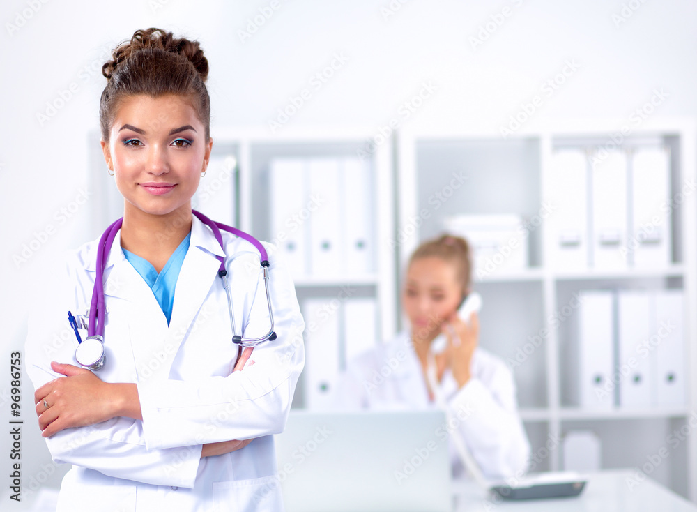 Portrait of young woman doctor with white coat standing in hospital Portrait of young woman doctor with white coat standing in hospital