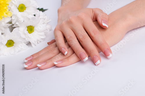 Beautiful french manicure with white daisies.
