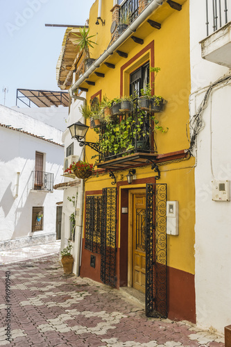 holiday, traditional Andalusian streets with flowers and white h photo