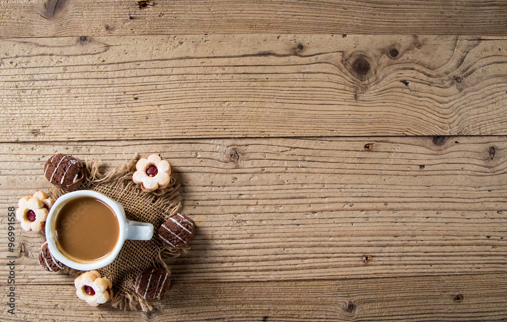 Christmas sweet rolls with coffee on brown wooden background. Christmas sweet rolls with coffee on brown wooden background.