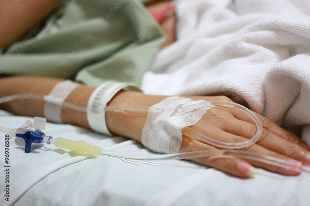 Fototapeta premium Saline solution on patients woman hand.