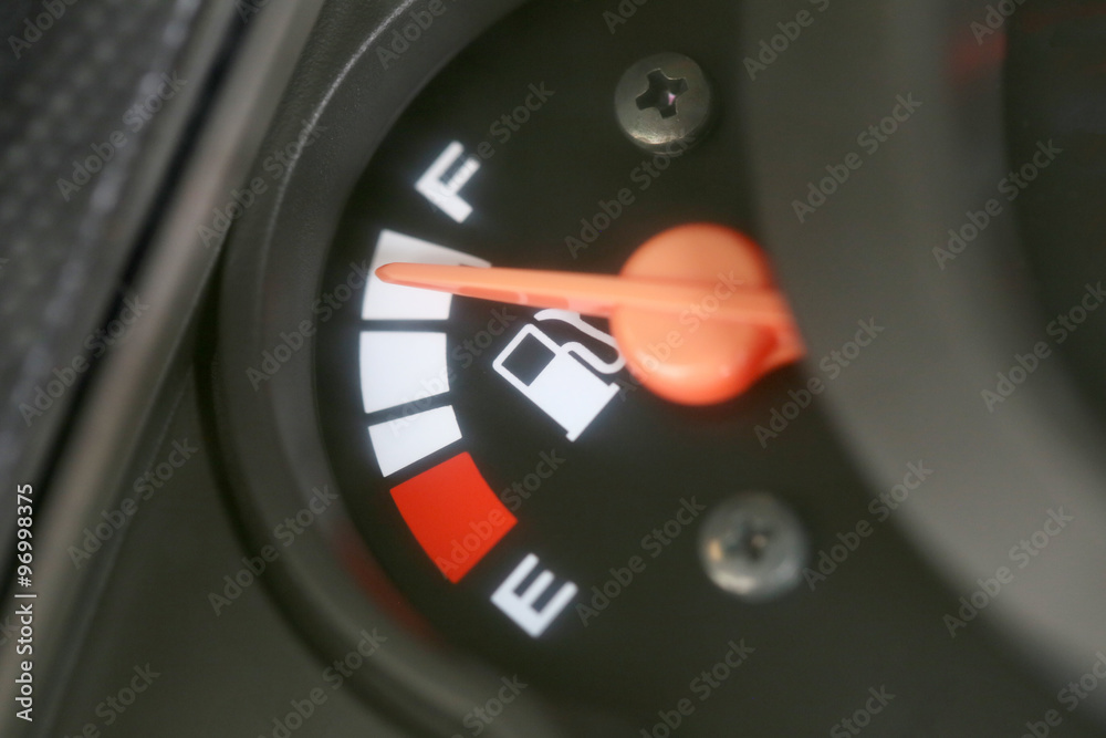 Naklejka premium Fuel gauge with warning indicating quantity fuel tank.
